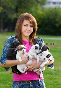 Young Women Holding Five Puppies