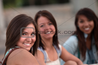 Three Cute Teen Girls Sitting