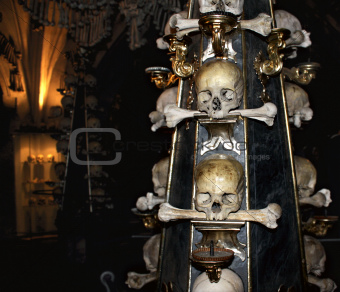 Candlestick with human skulls and bones