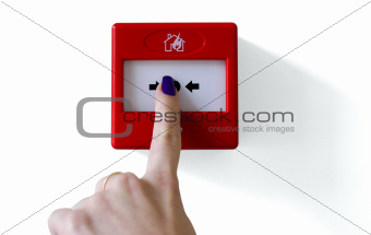 Fire alarm trigger button being pressed by female finger