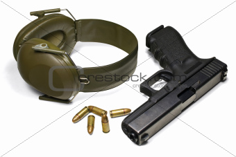 Pistol, ear protection and ammunition isolated on white
