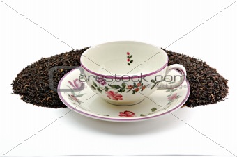Tea cup on scattered tea leafs