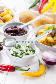 Sour cream and chutney with baked potatoes