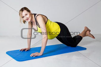 Pregnant woman doing push-up exercise