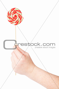 Hand holding colorful spiral lollipop