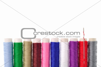 many-coloured bobbins of thread 