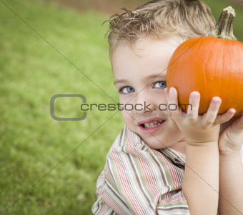 Adorable Young Child Boy Enjoying the Pumpkins at the Pumpkin Patch.