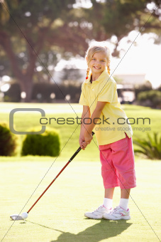 Young Girl Practising Golf On Putting On Green