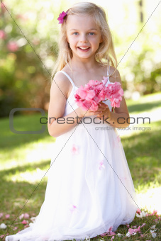 Portrait Of Bridesmaid Holding Bouquet Outdoors