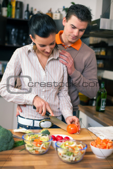 Young couple preparing lunch in kitchen 