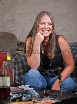 Smiling Woman with Knife Stuck in Table