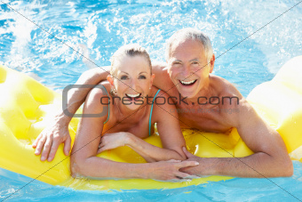 Senior couple having fun in pool