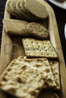 Various biscuits on a wooden plate