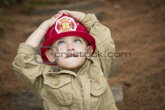 Happy Adorable Child Boy with Fireman Hat Playing Outside.