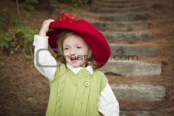Happy Adorable Child Girl with Red Hat Playing Outside.