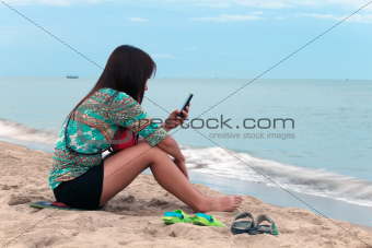 Asian woman sit on the beach.