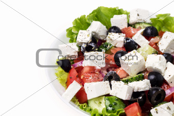 part of plate with greek salad