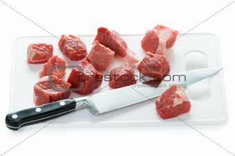 dicing raw lamb with a kitchen knife
