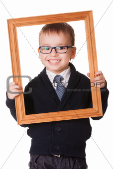 Smiling clever boy in wooden frame 