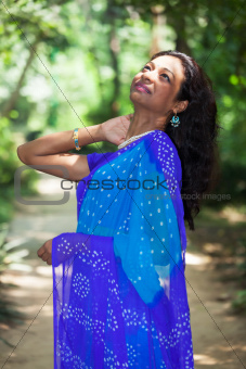 young indian woman in a saree outdoors 
