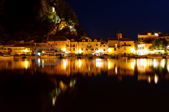 Illuminated Pirate Castle and Town of Omis Reflecting in the Cet