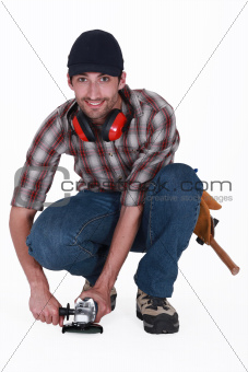 A handyman using a sander