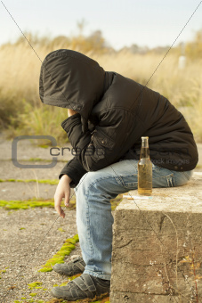 Boy with alcohol, cigarettes and syringe
