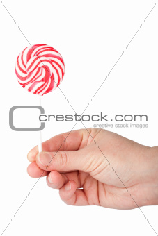 Hand holding spiral lollipop 