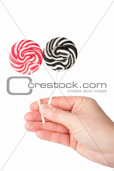 Hand holding lollipops