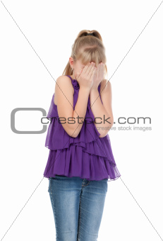 Young girl shyly covered her face with her hands