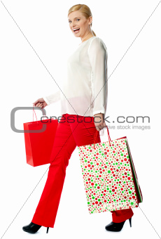 Pretty woman with shopping bags, walking