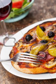 closeup of a pizza with red wine 
