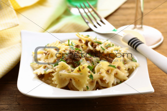 farfalle pasta with beef sauce  on  plate with  fork