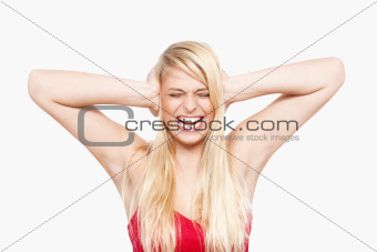young girl covering ears with her eyes closed, mouth open - isolated on white