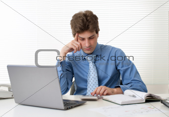 Busy businessman with laptop computer