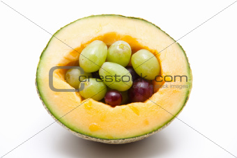 Half a melon with grapes