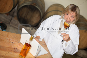 wine expert tasting wine in a cellar