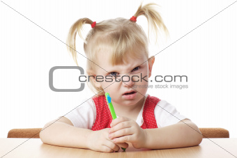 displeased child with toothbrush