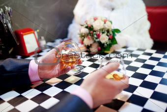 two glasses of cognac in the hands of male