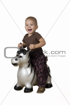 Child on an inflatable horse (white background)