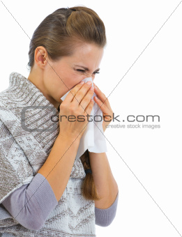 Woman having running nose and using napkin