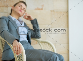 Closeup on tired business woman relaxing on chair