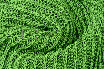 close up green knitted pullover background