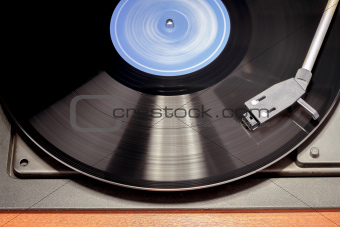 Vintage record player with spinning vinyl. Motion blur image. 