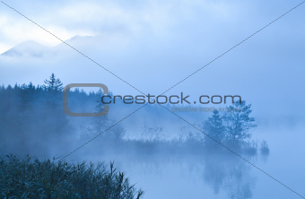 Barmsee and mounrains in morning fog