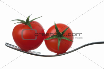 two cherry tomatoes on a fork