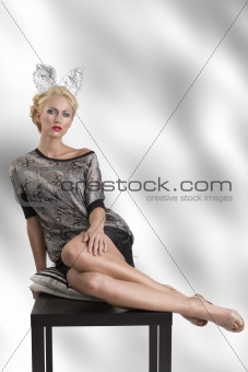 sexy girl with silver bunny ears looks in to the lens