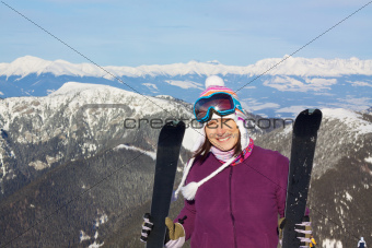 Pretty girl in mountains skiing