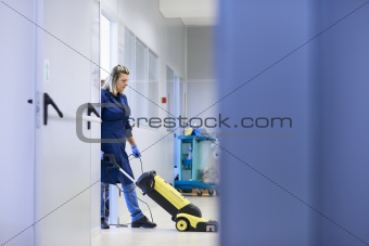 Women at workplace, professional female cleaner washing floor in