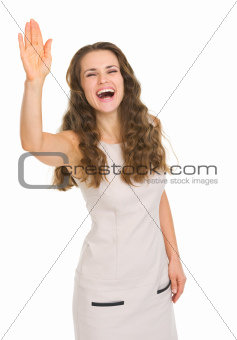 Smiling young woman in dress saluting
